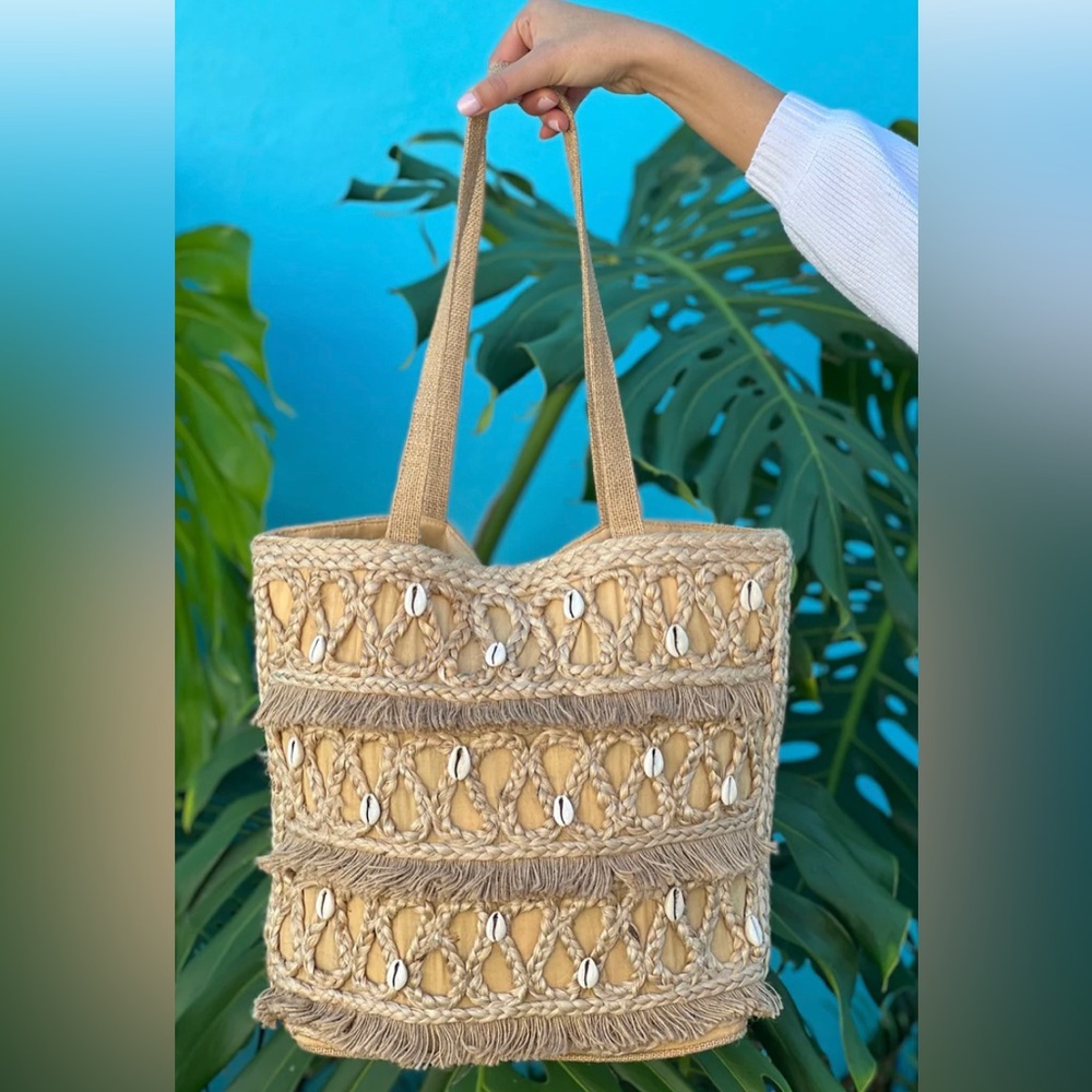 Natural jute is hand-braided with a touch of bohemian fringe.